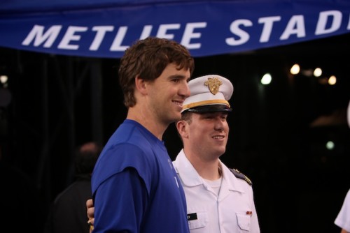 New York Giants quarterback Eli Manning poses for a photo with a cadet during a pre-game, Sept. 19, East Rutherford N.J. Seventy-Five cadets unfuled a ceremonial American Flag prior to the kick-off of Monday Night Footbal Photo by Tommy Gilligan/West Point Public Affairs