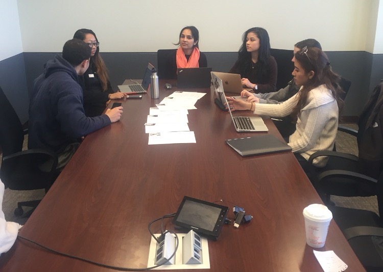 Assistant Professor of Marketing, Manveer Mann (middle) during a group fashion show meeting at the Feliciano School of Business. Photo Credit: Bryant Rosario