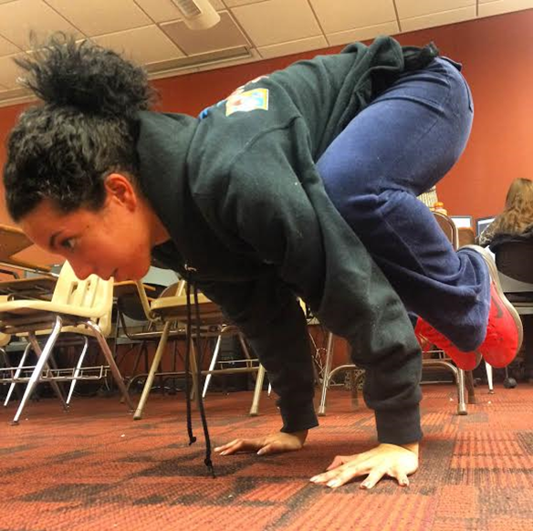 Senior student Adriana Avila building strength through the “crow” pose.