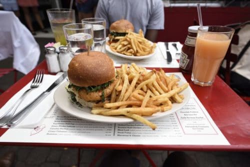 A salmon burger with fries can be enjoyed at Raymond's, a restaurant located in Montclair, New Jersey — only a few minutes away from Montclair State's campus. Photo by Tunmise Odufuye