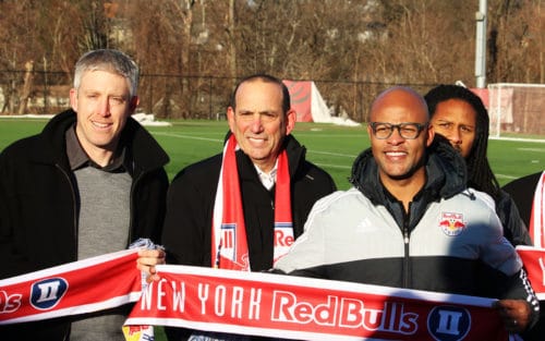 MLS Commissioner Don Garber (center) was named the New York Red Bulls II first season ticket holder on Monday at Montclair State, and joined by Red Bulls II Head Coach John Wolyniec (left), Red Bulls Sporting Director Ali Curtis (right) and other members of the Montclair soccer community. Photo by Dan Falkenheim