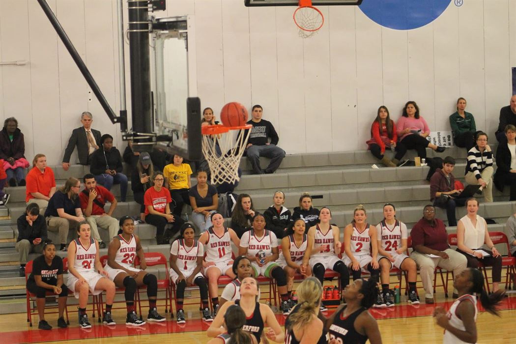 The Montclair State bench watches as the ball goes in the hoop.