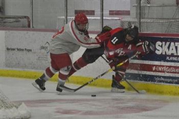 The Red Hawks defend the puck. Photo Credit: Patrick Eskay