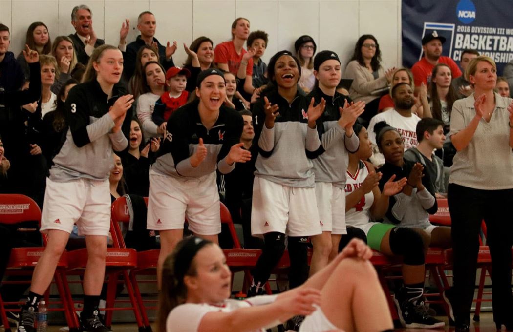 Montclair players cheer after their teammate Zoe Curtis scored a basket. The Redhawks won 76 to 67 to advance to the NJAC finals on Saturday versus Rutgers Newark. Photo by Therese Sheridan