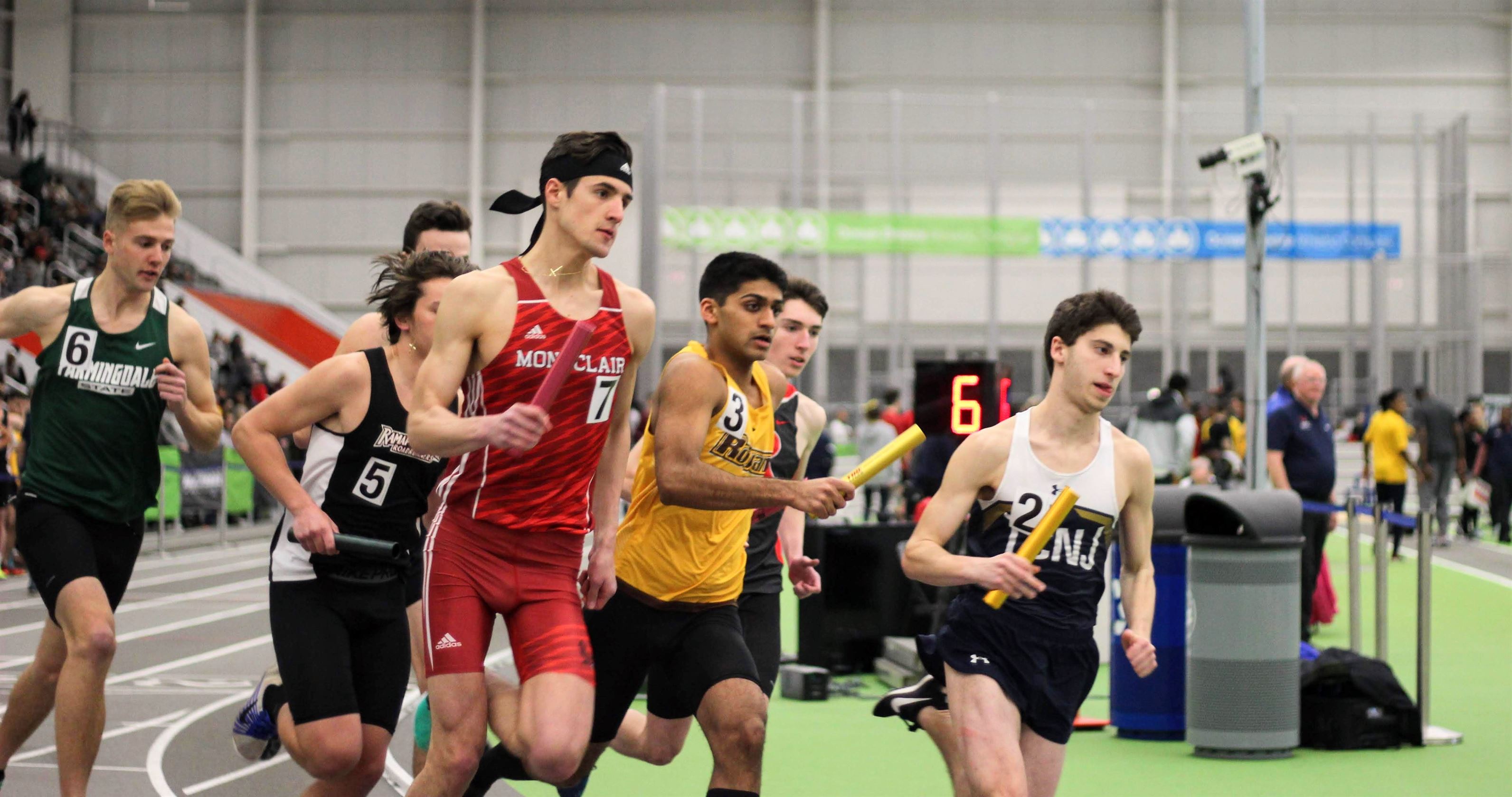 Carmichael running in a relay race for the Red Hawks. Ben Caplan | The Montclarion