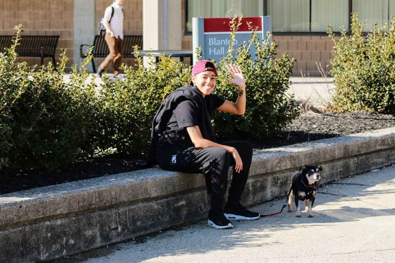 A student sits outside of Blanton Hall with her dog. Olivia Kearns | The Montclarion