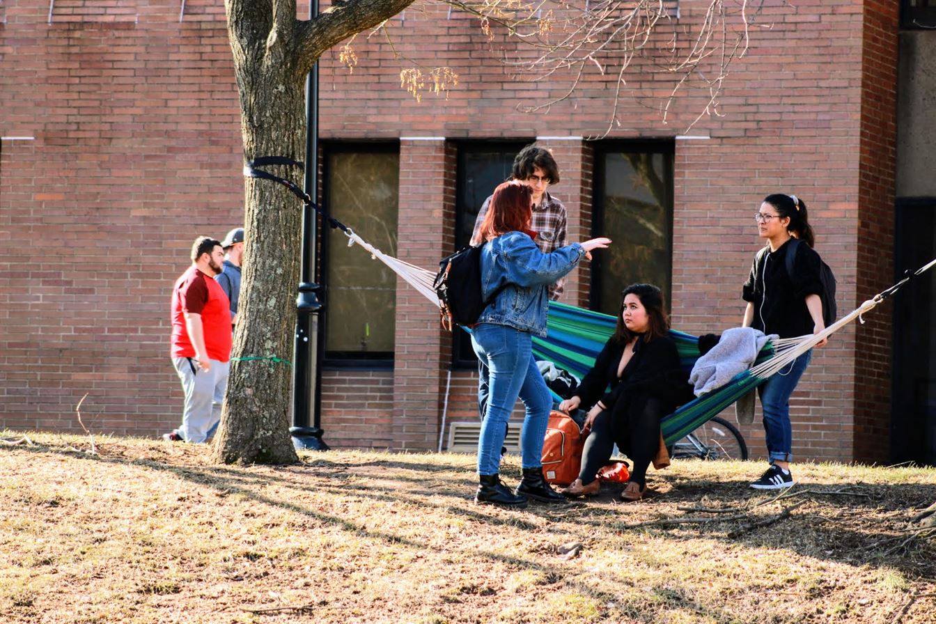 A group of friends hangs out on a hammock in front of Calcia Hall. Olivia Kearns | The Montclarion