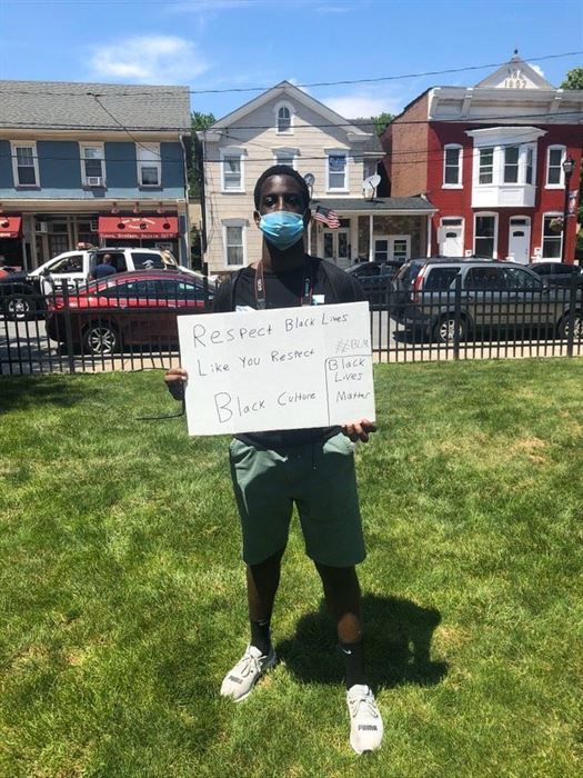 Corey Annan poses with his sign at the Phillipsburg protest. Corey Annan | The Montclarion