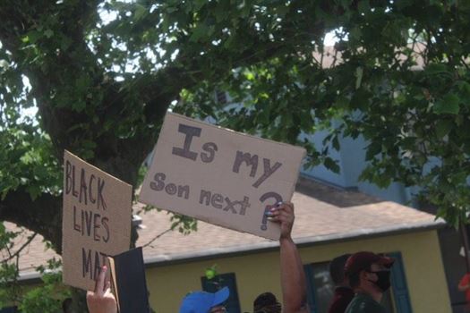 A picture of a powerful sign is taken at the Phillipsburg protest. Corey Annan | The Montclarion
