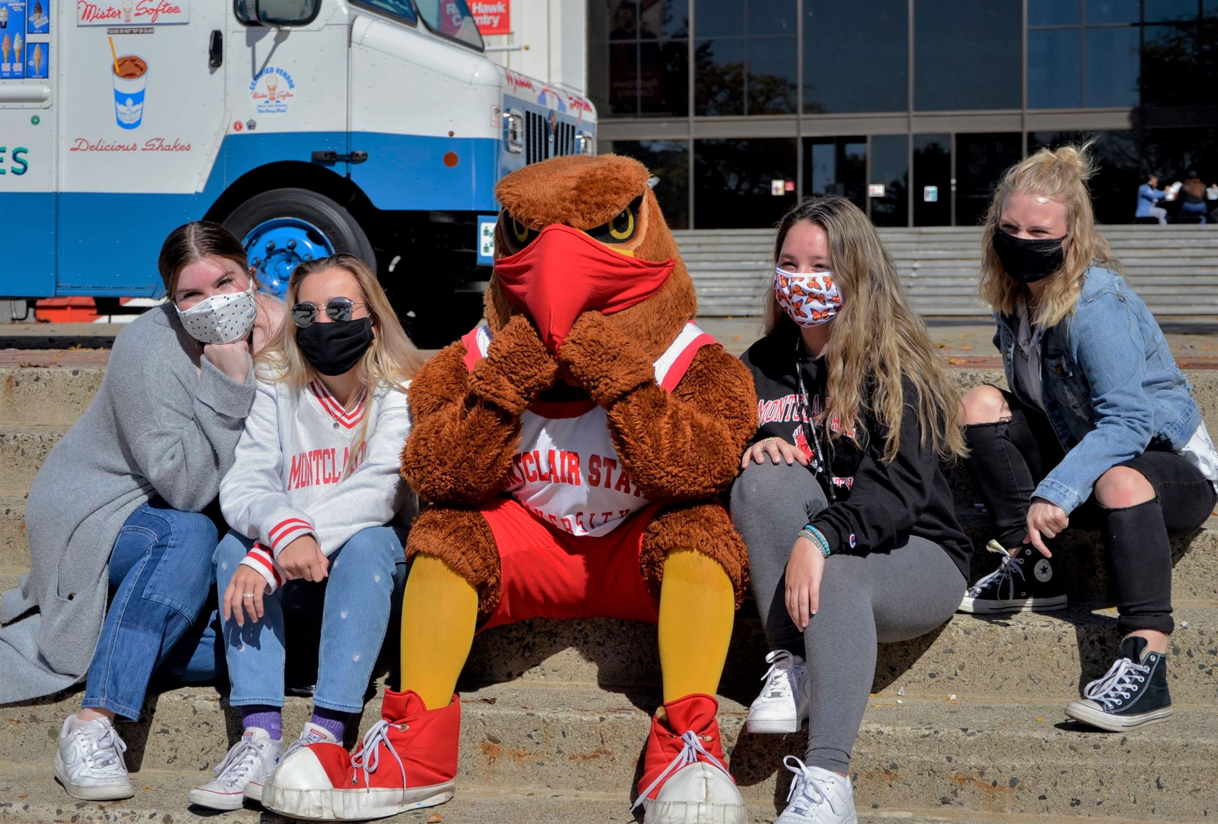 Montclair State freshmen Kate Repp, Faith Wolf, Remy Grato and Hannah Ranzan pose with Rocky the Red Hawk on the stairs in front of the Student Center, during University Day. Photo courtesy of John LaRosa