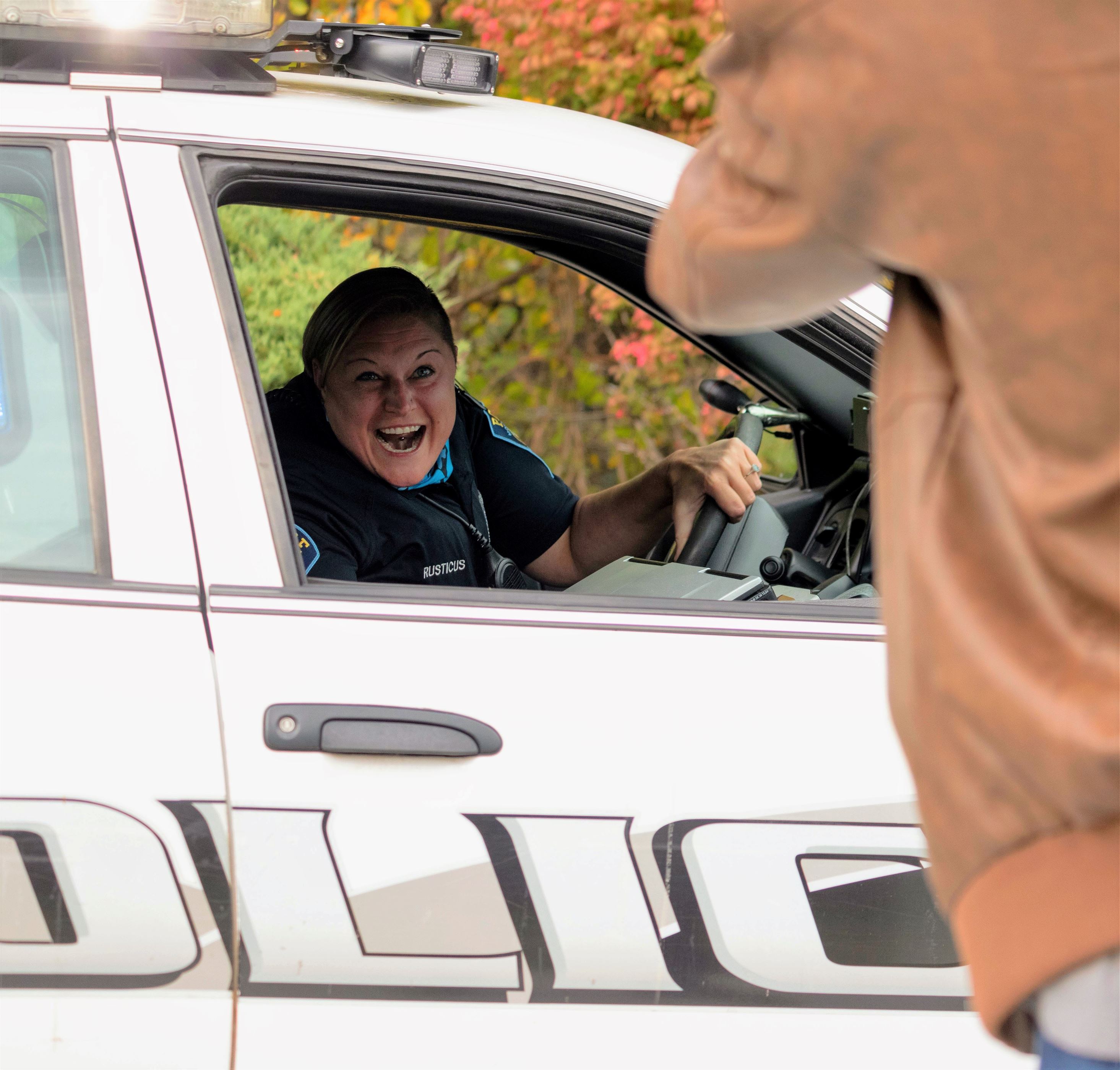 Montclair State University police officer, Amanda Rusticus, wishes Rocky a happy birthday at the end of the his golf cart parade, near Montclair State Ice Arena. Sunah Choudhry | The Montclarion