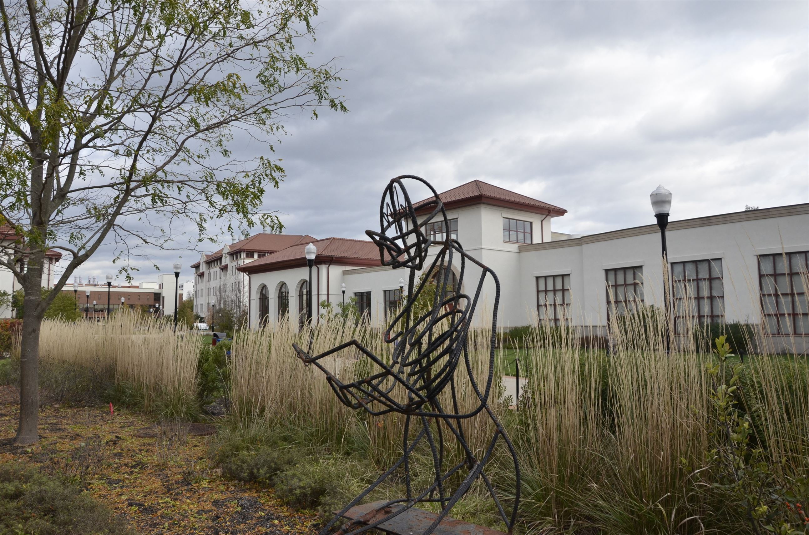 A wire statue of a man reading outside of Sprague Library at Montclair State University. John LaRosa | The Montclarion