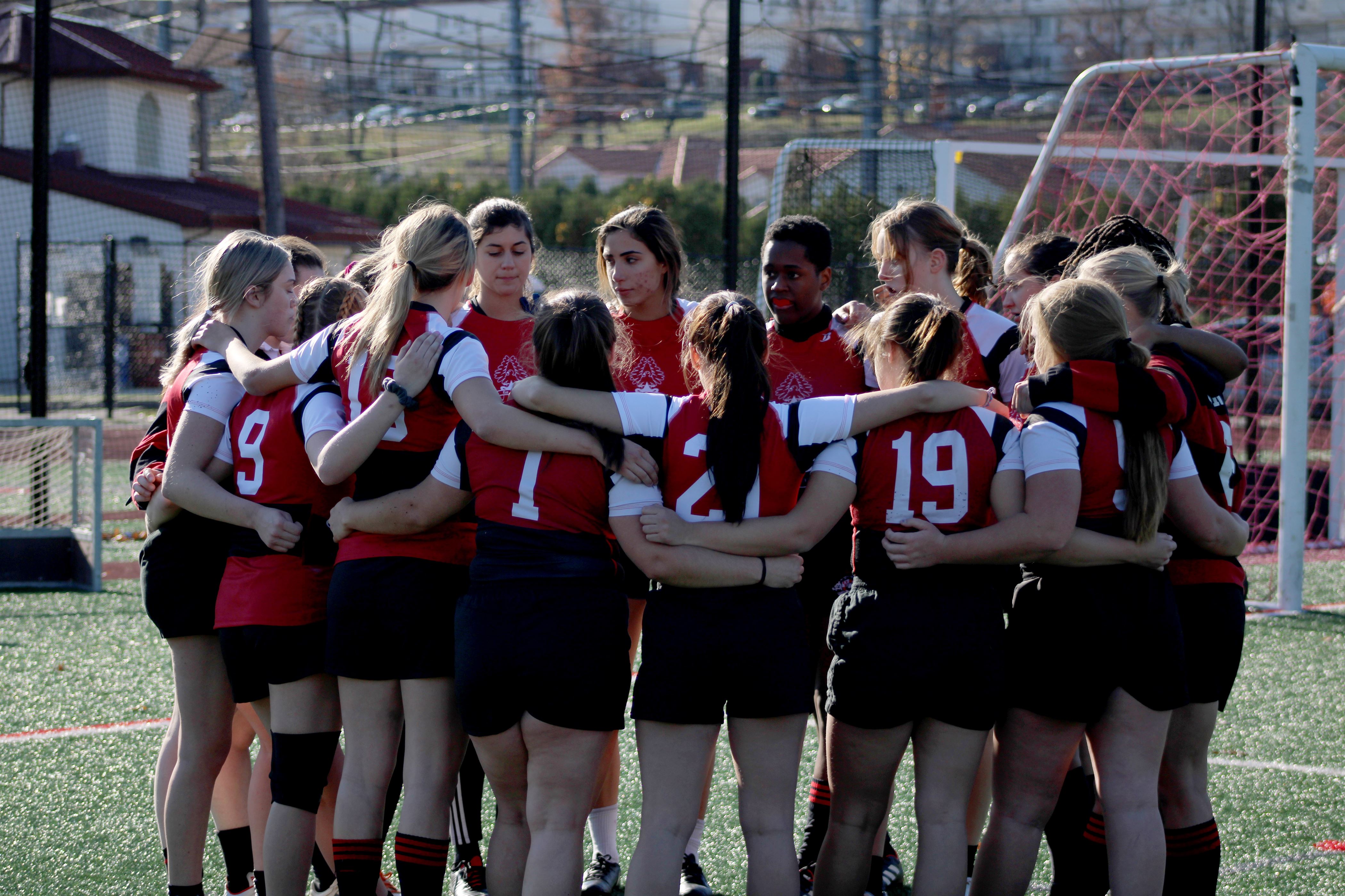 Montclair State women's rugby players lock arms and share motivational words before the start of their intra-squad scrimmage. Corey Annan | The Montclarion