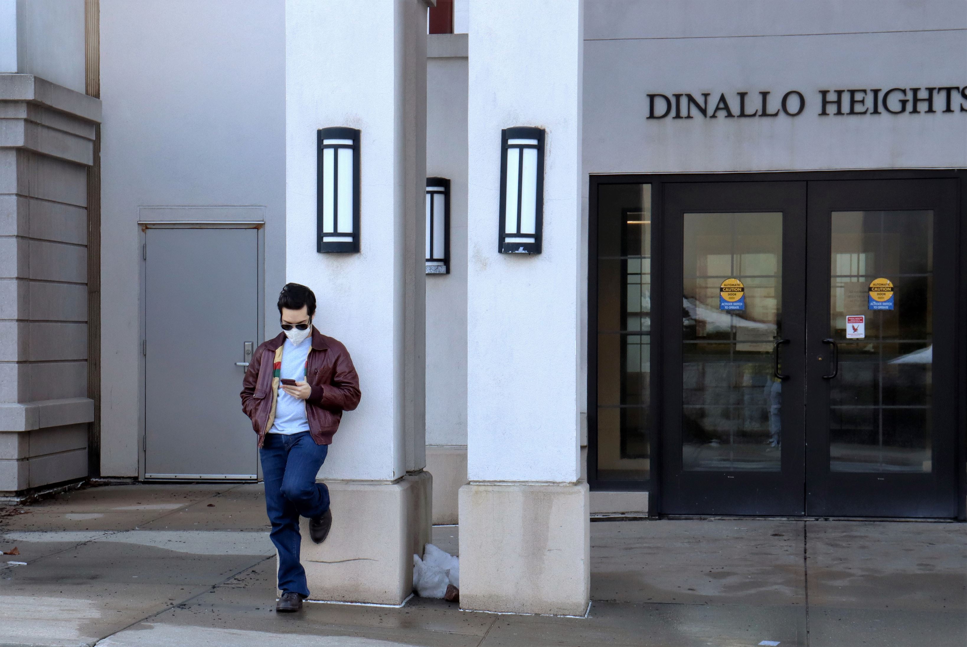 A student waits for a ride outside of Dinallo Heights. John La Rosa | The Montclarion