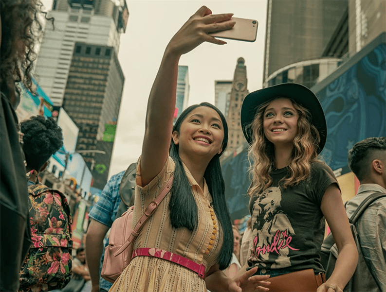 Lara Jean (Lana Condor) and Christine (Madeleine Arthur) snap a selfie in New York City. Photo Courtesy of Netflix