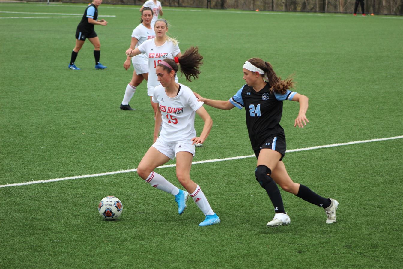 Red Hawks junior midfielder Emily DeGeyter tries to keep the ball away from a Stockton defender during the NJAC Semifinal game on April 10. Trevor Giesberg | The Montclarion