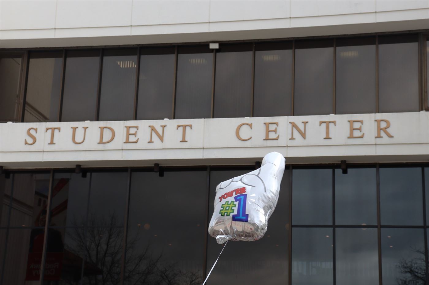 A balloon tailing behind a gold kart overlooking the Student Center. John LaRosa | The Montclarion