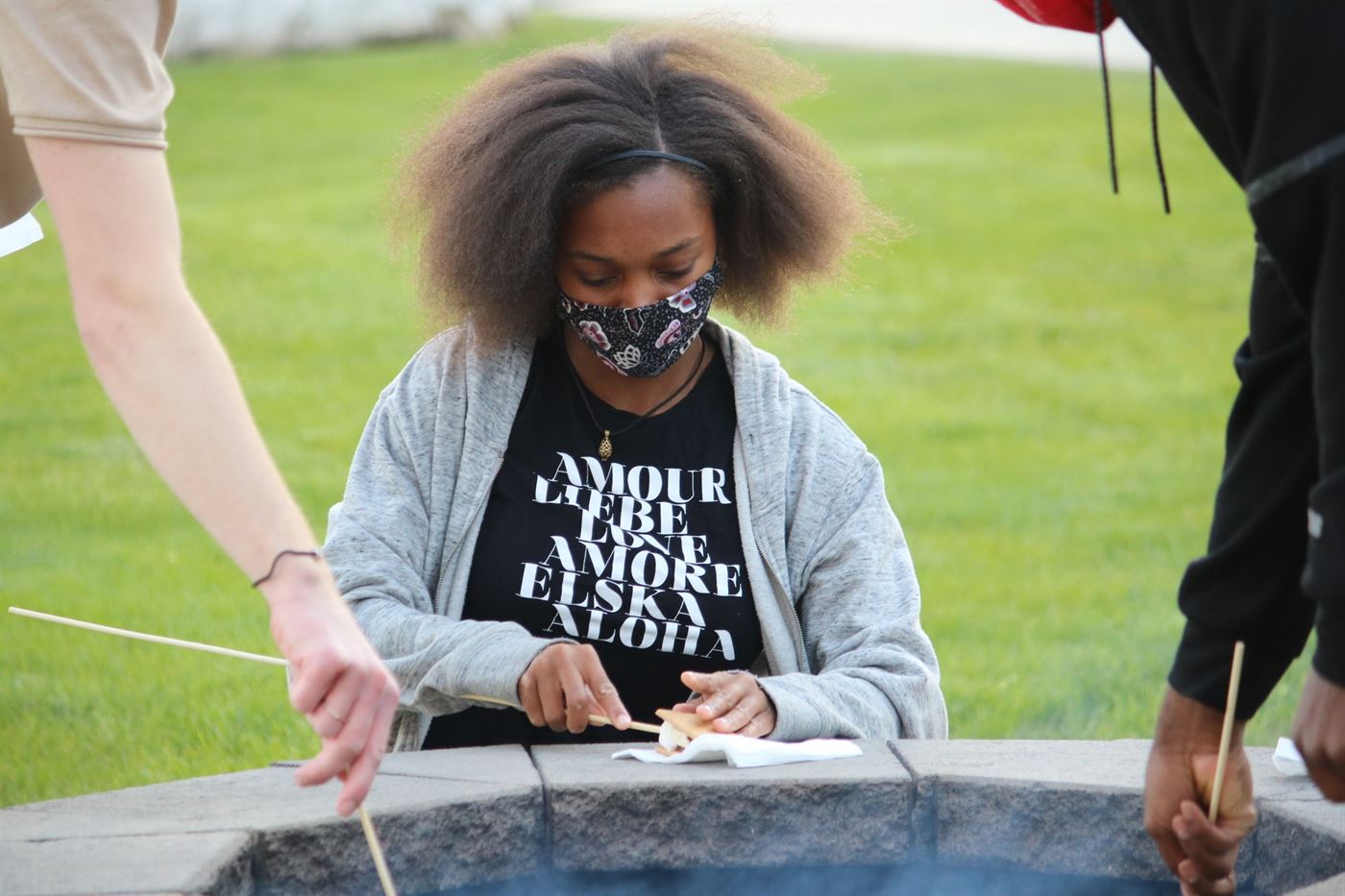 Deovionn Gaynor, a freshman dance major, builds a s'more during a bonfire at the Friday Night Fire Pit. Kyra Maffia | The Montclarion