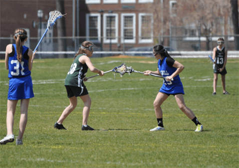 Costigan in Middle School playing against Livingston in her early years of lacrosse, on the draw control. Photo courtesy of Brittany Costigan