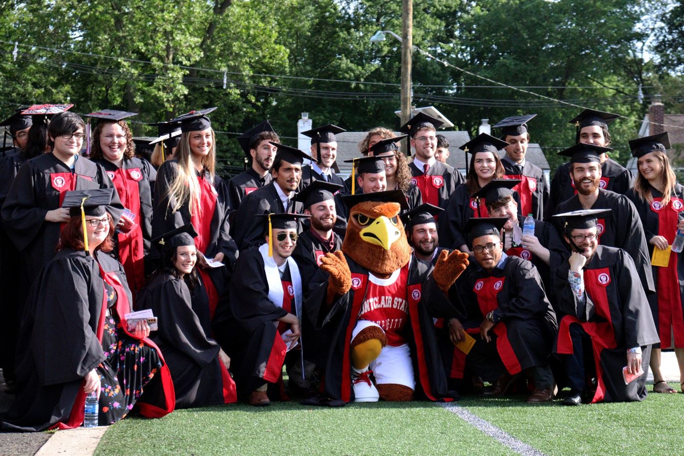 Rocky the Redhawk gathers around some of his classmates for one final picture. John LaRosa | The Montclarion