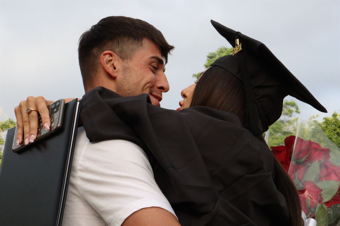 Two lovers embrace at graduation. John LaRosa | The Montclarion