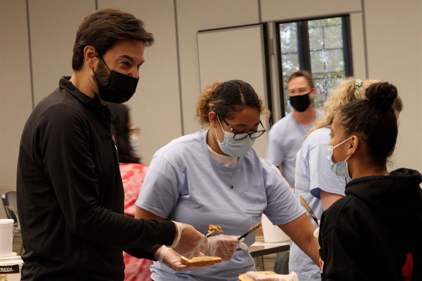 President Koppell helping Eugenia Vasquez Arango (middle) and other students make peanut butter sandwiches. John LaRosa | The Montclarion
