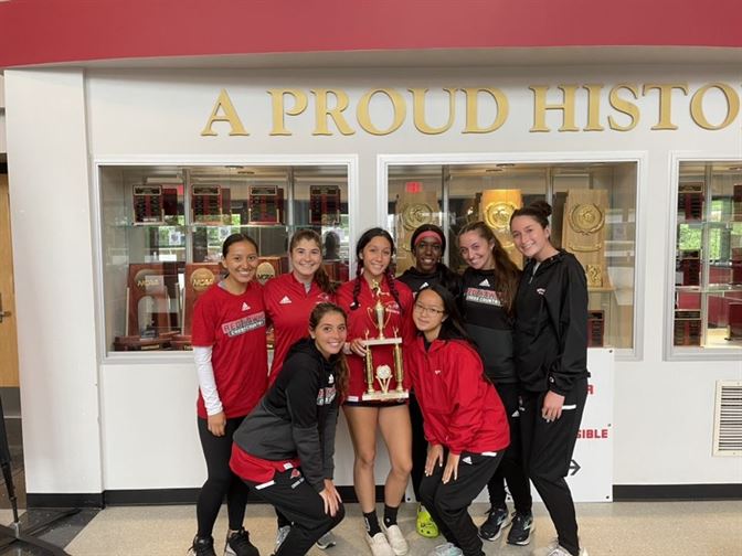 The women's cross country team poses with their 3rd place trophy at the Golden Eagle Invitational Photo courtesy of