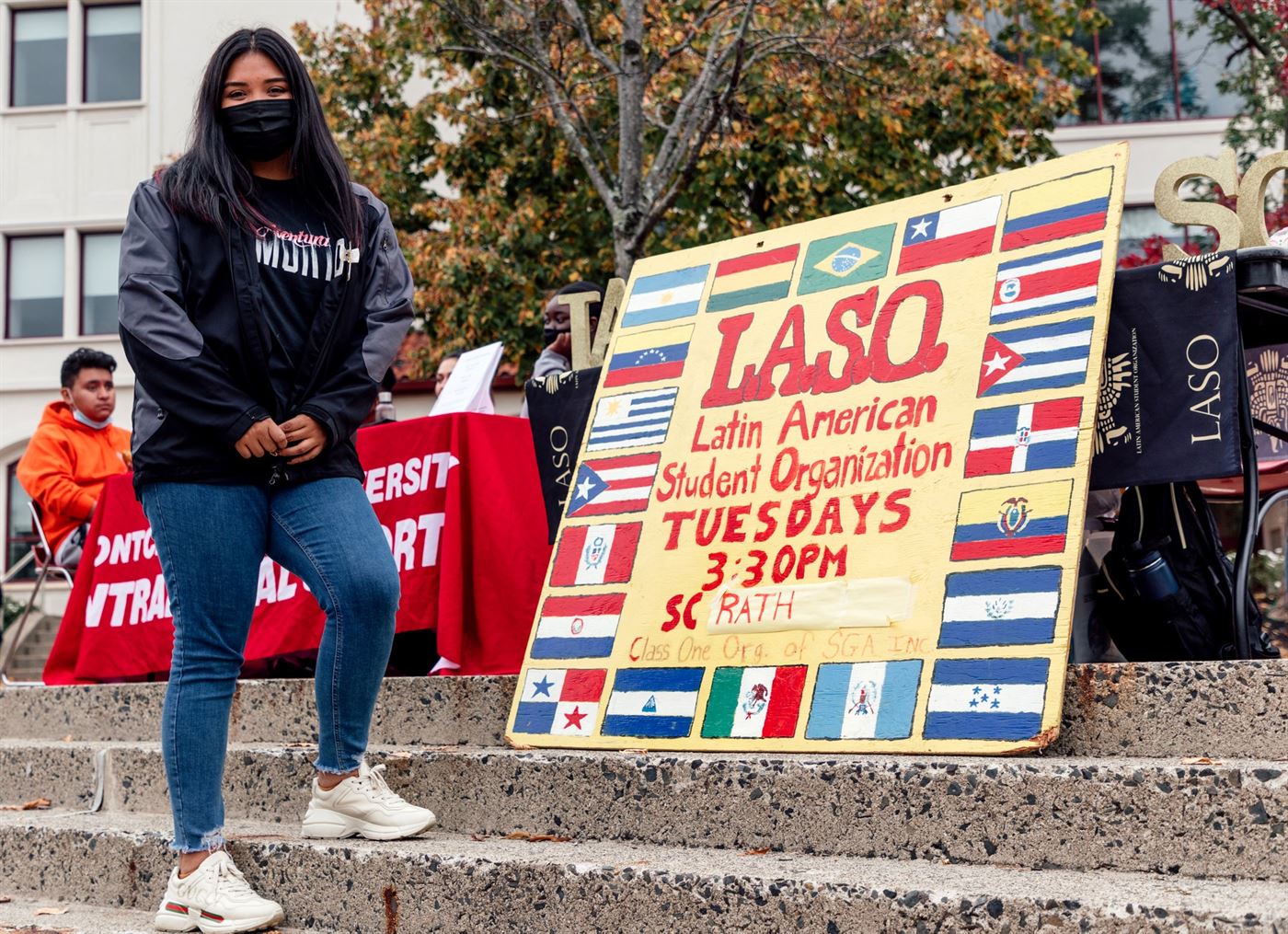 A member of LASO standing next to their sign at the Student Center Quad. Photo courtesy of Karsten Englander
