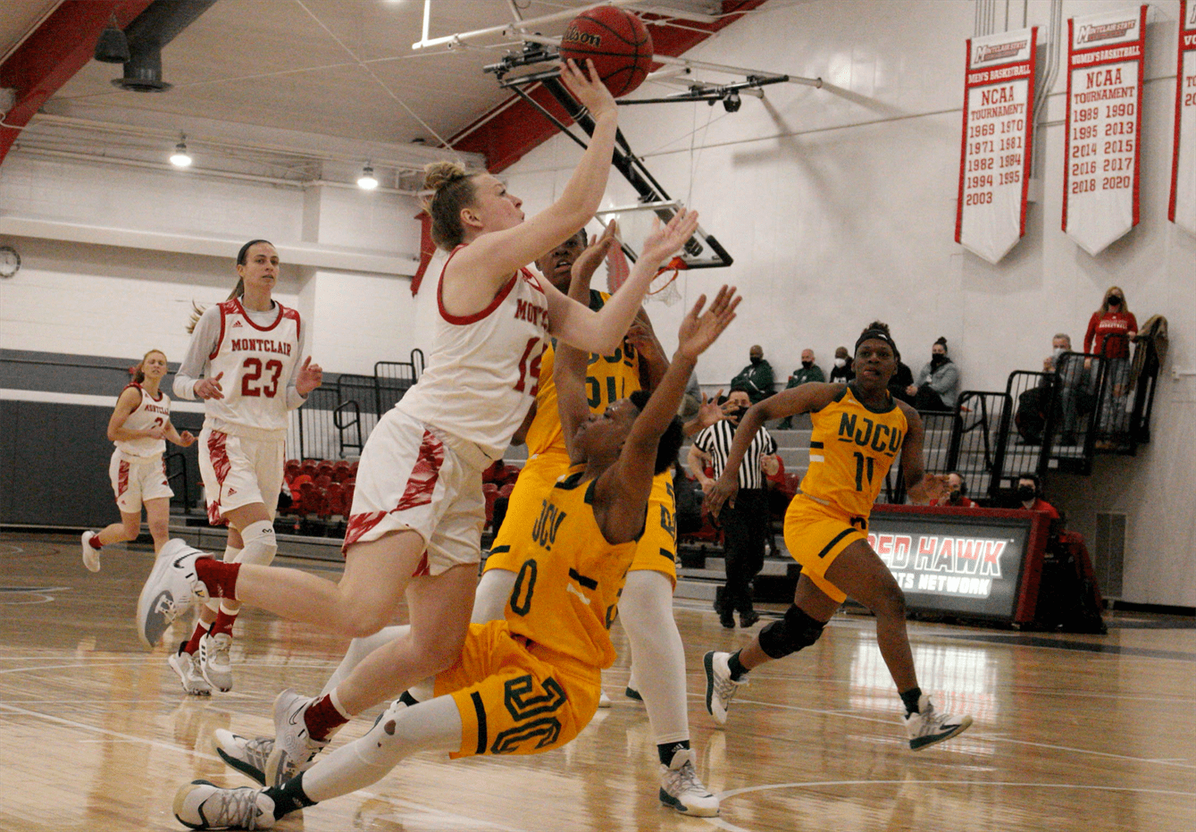 Junior guard Nickie Carter slams into an NJCU defender as she attempts a shot close to the rim. Photo courtesy of Caitlyn Hughes