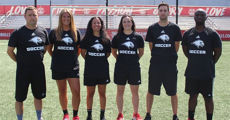 Erin Sullivan (second from left) poses for a photo alongside the women's soccer coaching staff. Photo courtesy of Montclair State Athletics