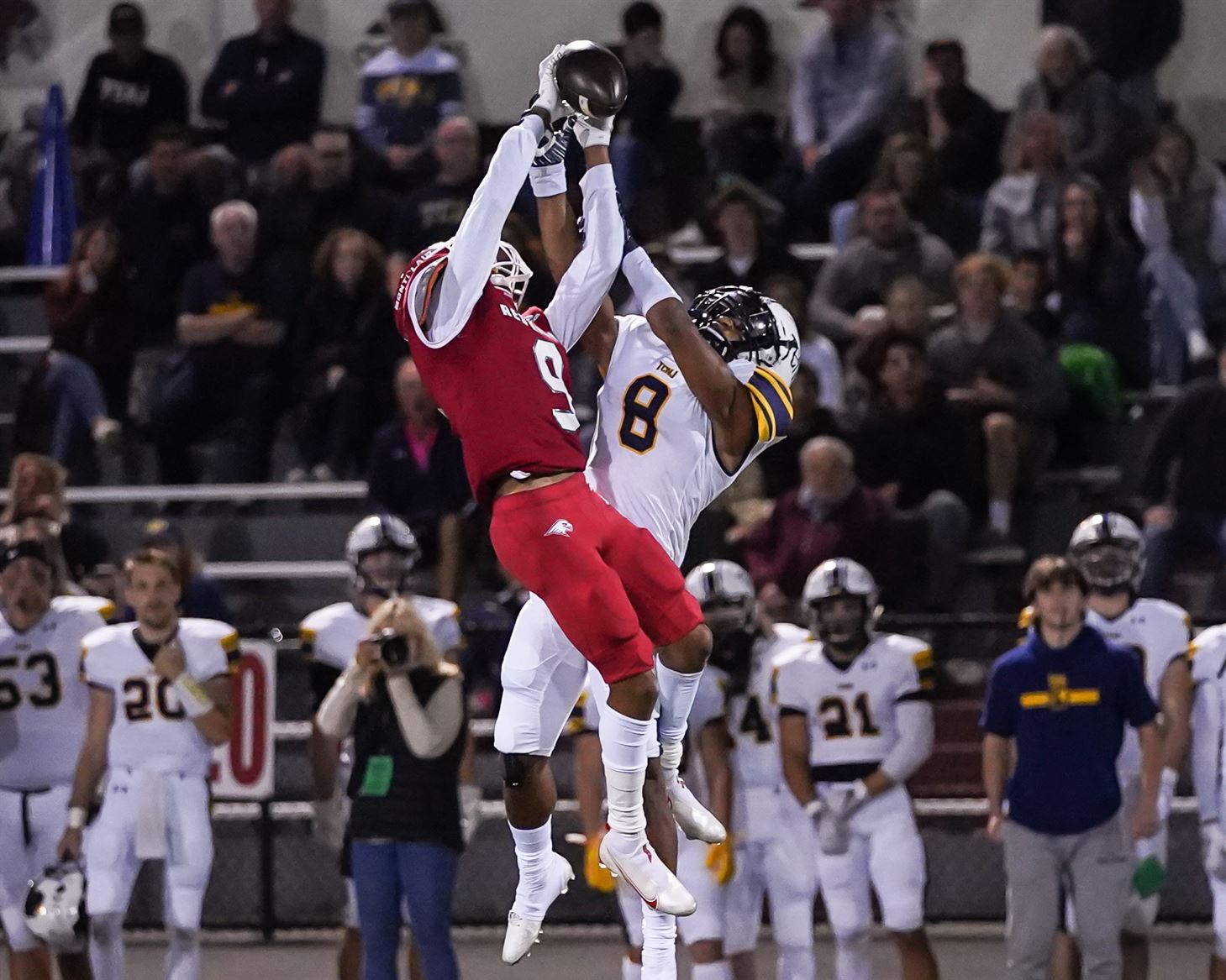 Junior wide receiver Clarence Wilkins reaches up to grab a pass over a defender from The College of New Jersey. Photo courtesy of David Venezia