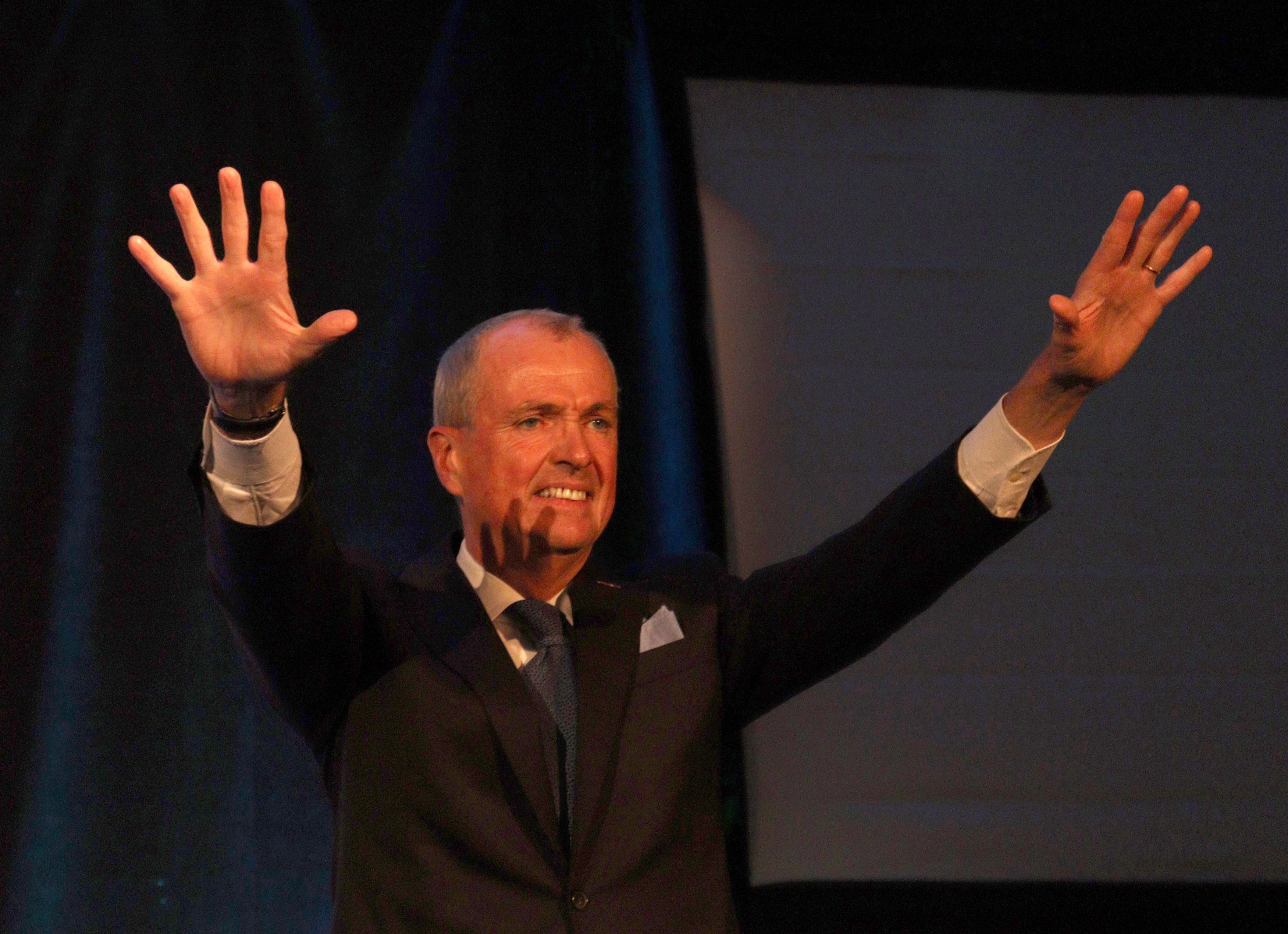 Gov. Phil Murphy takes the stage and waves to supporters at his reelection party in Asbury Park, New Jersey. John LaRosa | The Montclarion