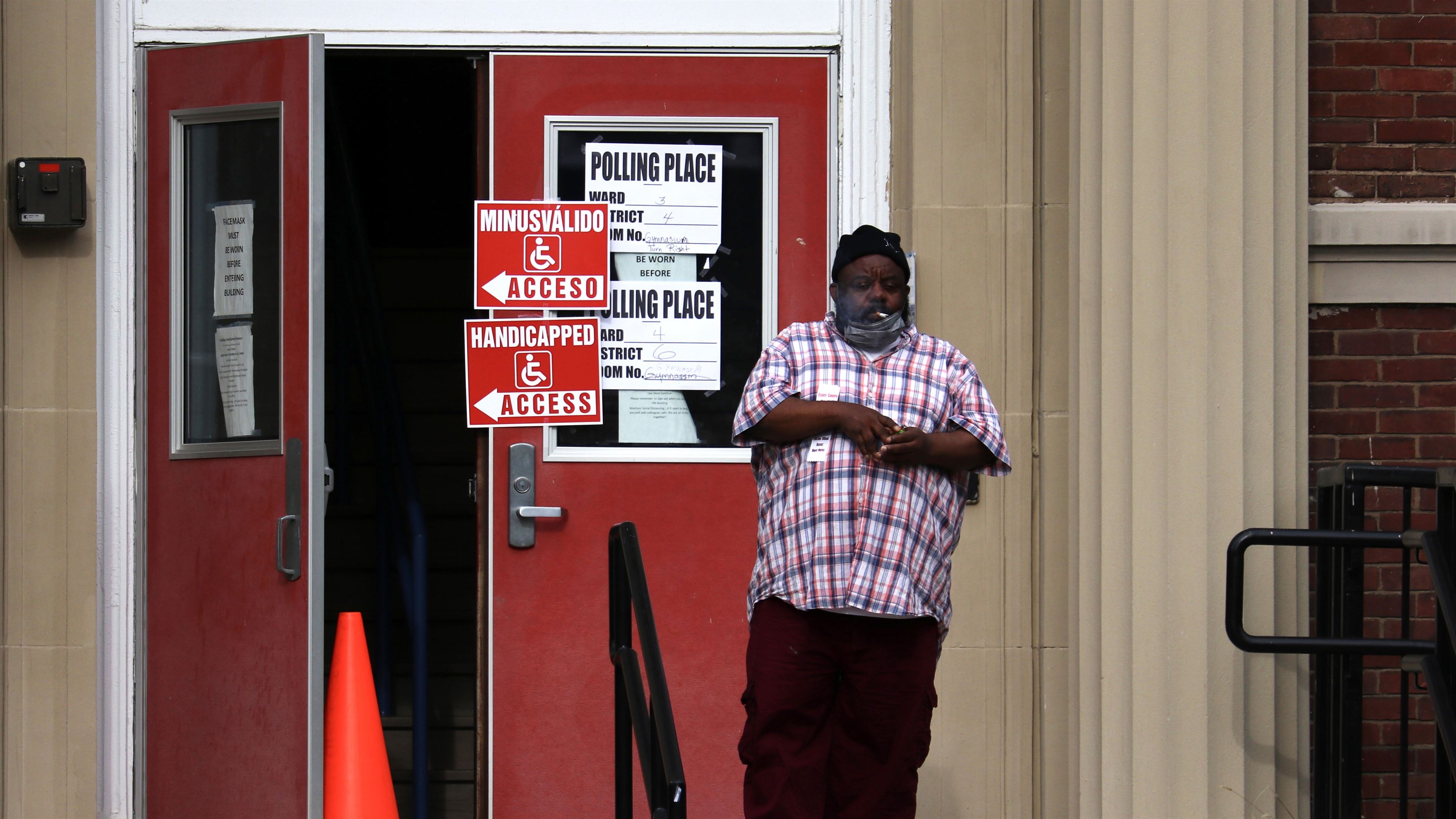 A man lights a cigarette outside of Montclair’s Nishuane Elementary School after voting. Photo courtesy of Caleb Levine