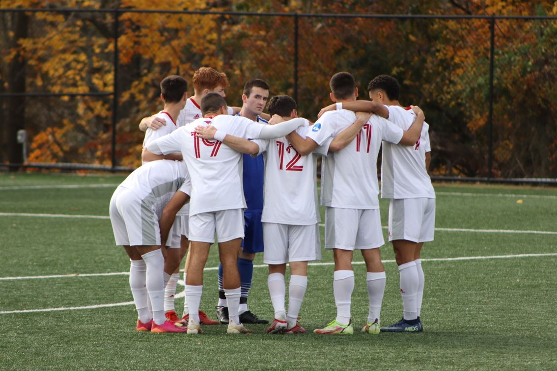 The Red Hawks huddle up prior to their first round matchup against Gordon College. Trevor Giesberg | The Montclarion