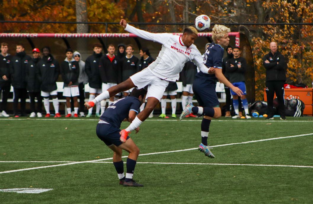 Sophomore midfielder/forward Gene Carlo Altamirano leaps up in the air for a header during the team's NCAA First Round contest against Gordon College. Trevor Giesberg | The Montclarion