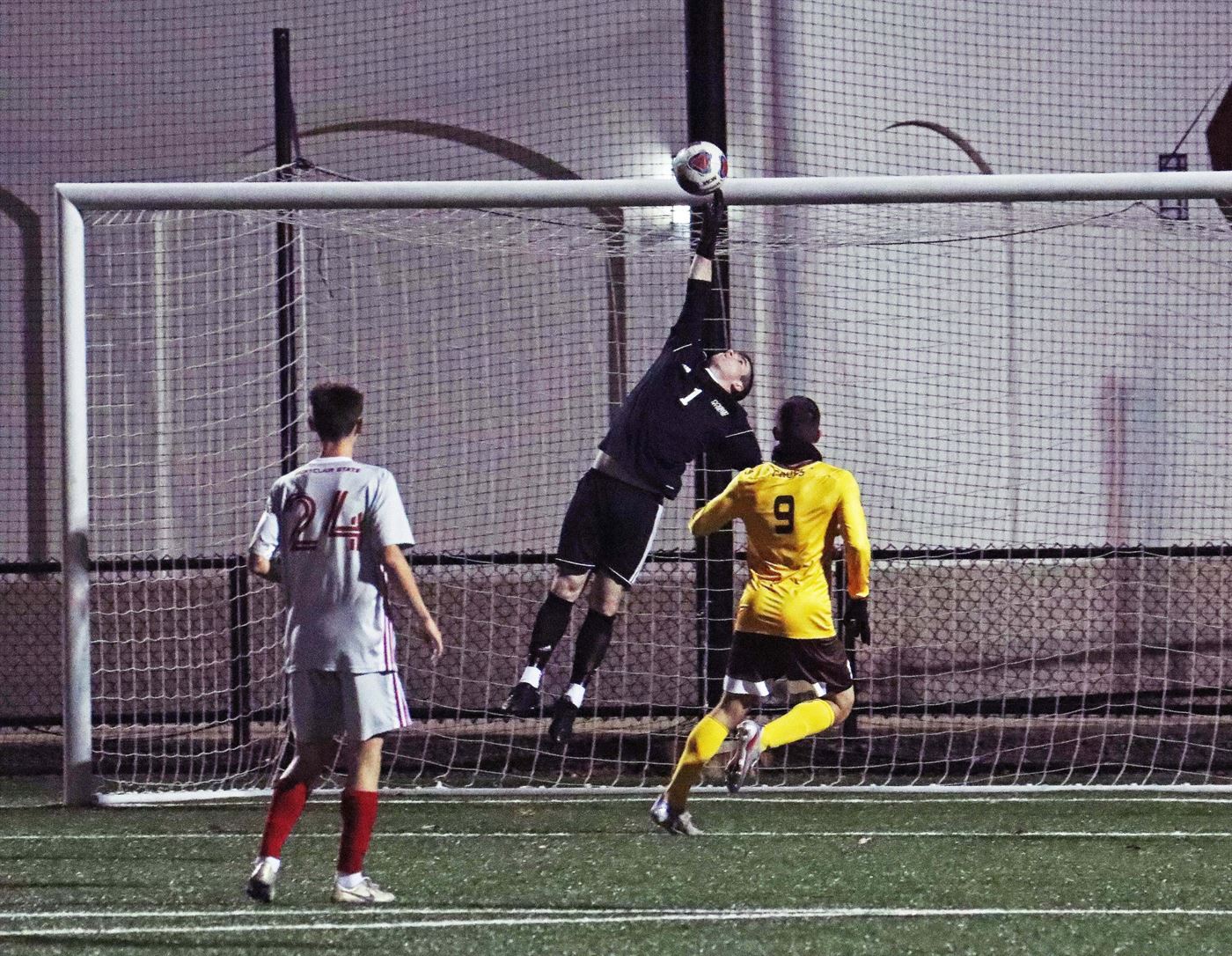 Senior goalkeeper Shane Keenan secures a save after a shot from one of Rowan University's strikers. Photo courtesy of Julian Rigg
