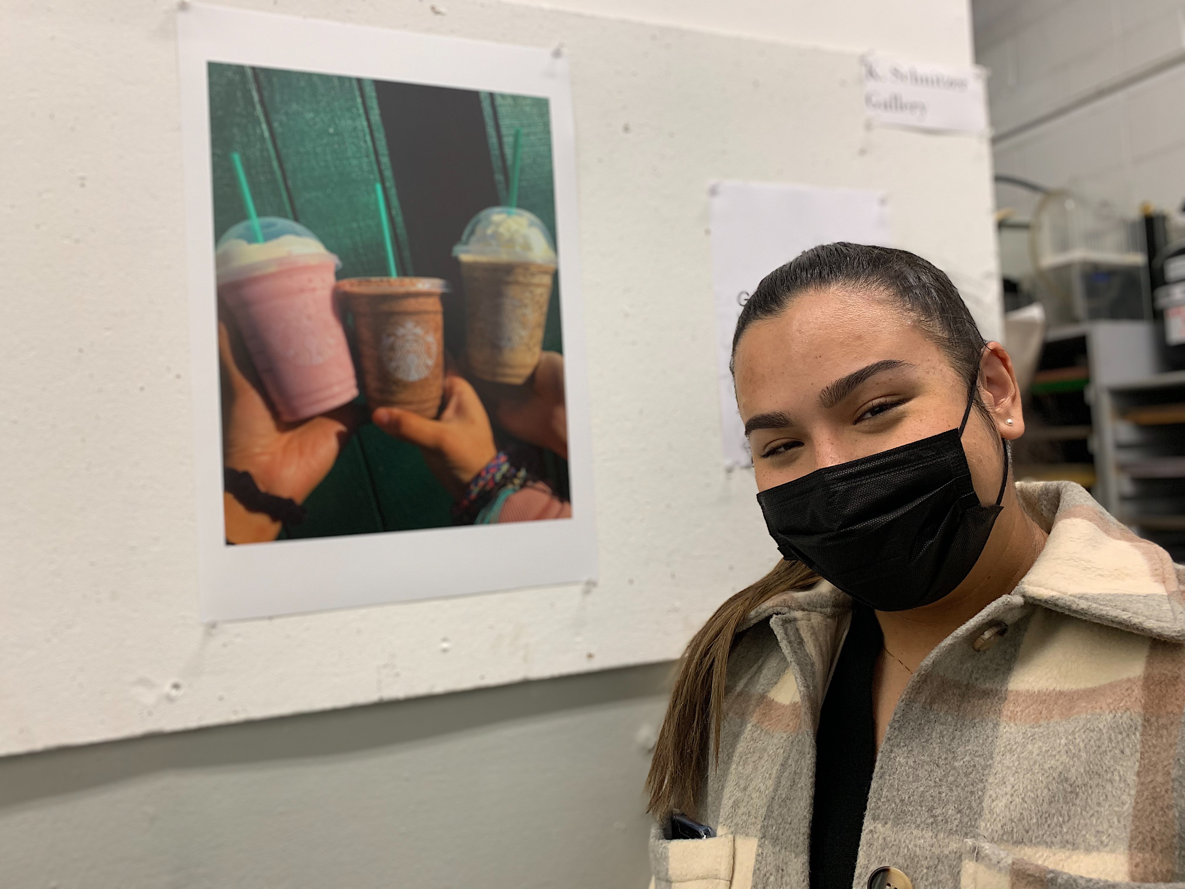 Stephanie Arango proudly stands by her photo produced this semester. Sekhena Sembenu | The Montclarion