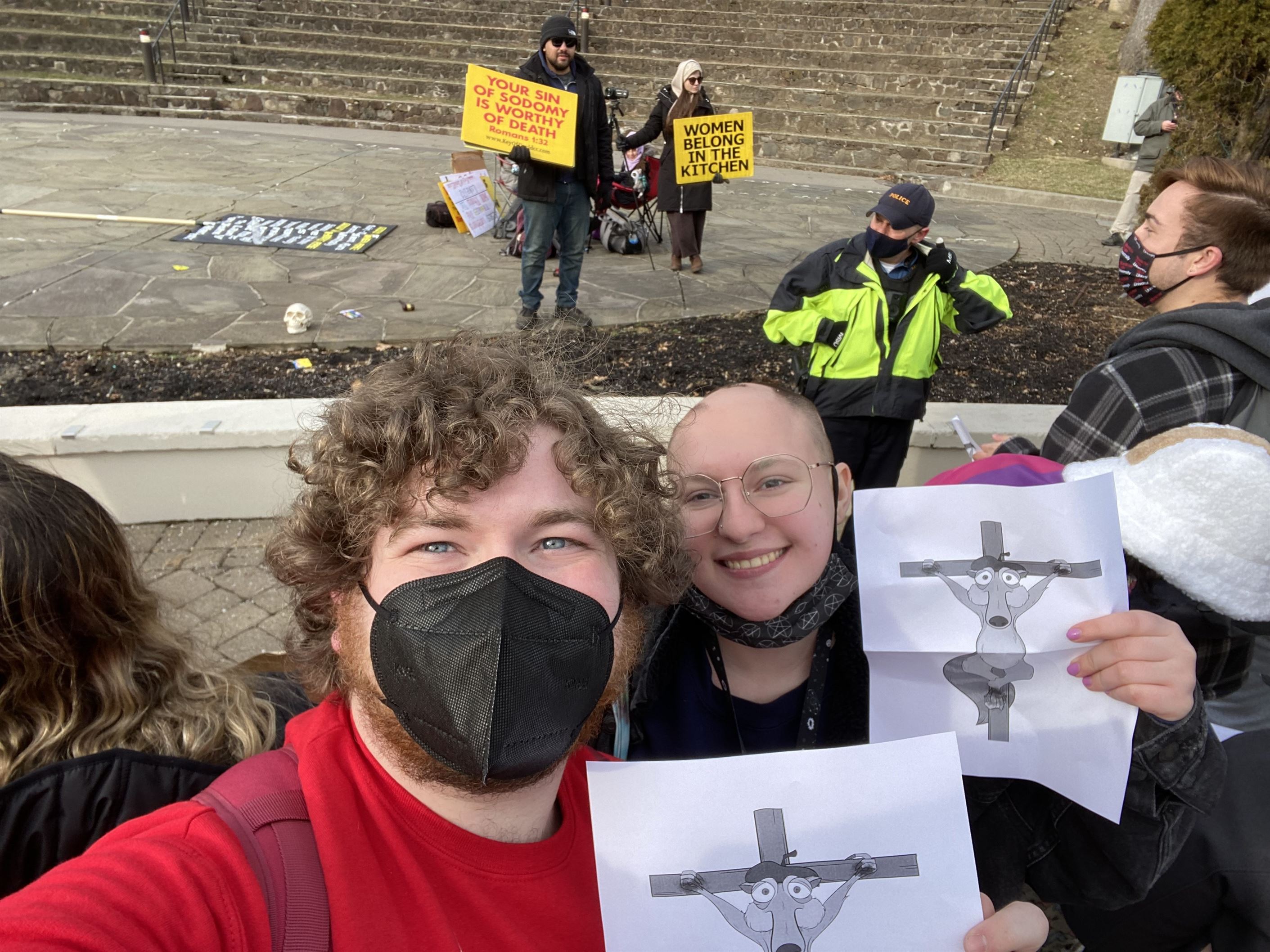 Colin Luderitz (left) and Sam Garofolo (right) holding up a picture of Scrat from “Ice Age” being crucified in front of the David Christian Center members. Photo courtesy of Colin Luderitz