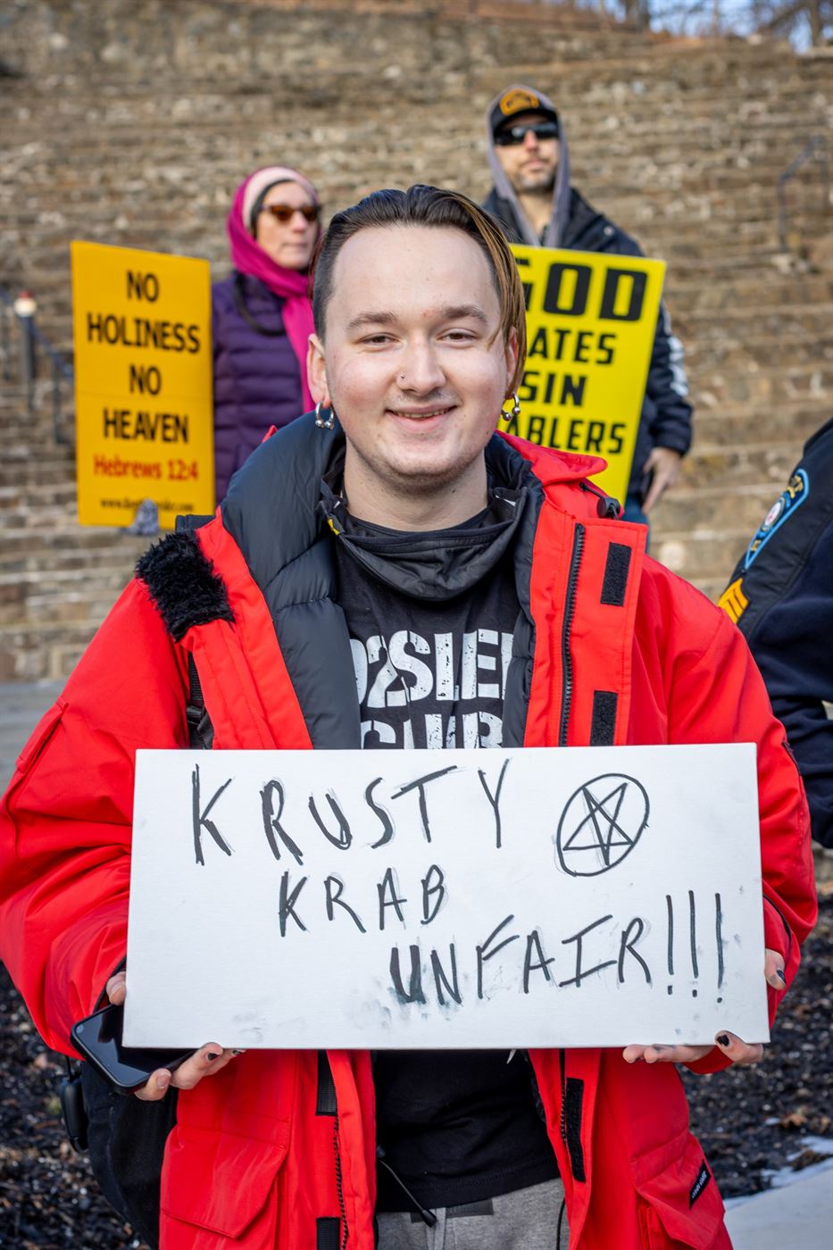 A student holds up a "Krusty Krab Unfair" sign, mocking the protesters. John LaRosa | The Montclarion