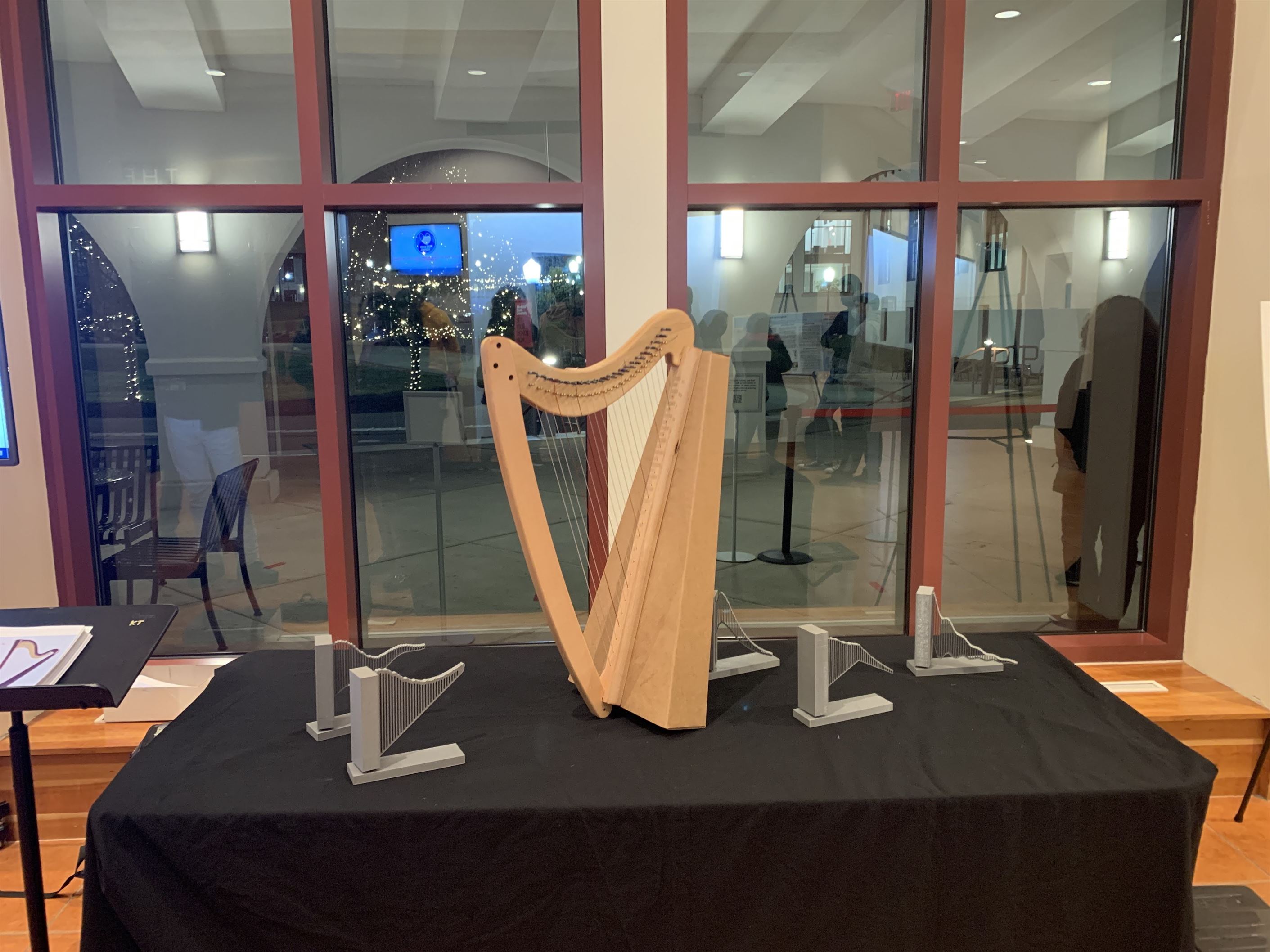 3D printed models of new harp shapes next to a traditional harp. Photo courtesy of Bogdan Nita
