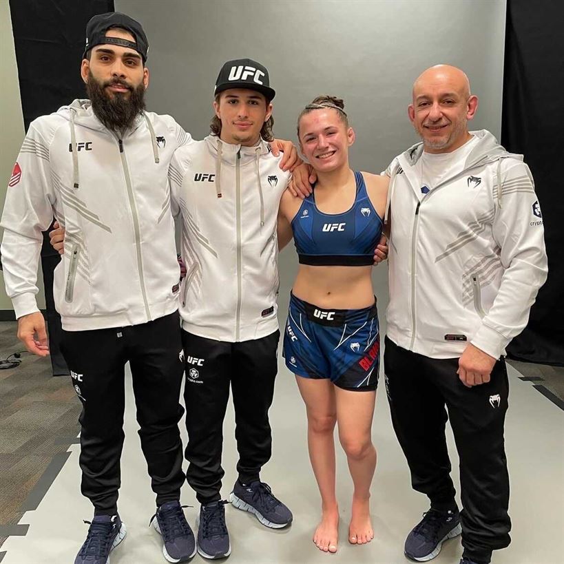 Blanchfield poses with her coaches Frankie Roberts (far left) and Augie Matias (far right) along with her little brother Brendan Blanchfield (middle). Photo courtesy of Erin Blanchfield