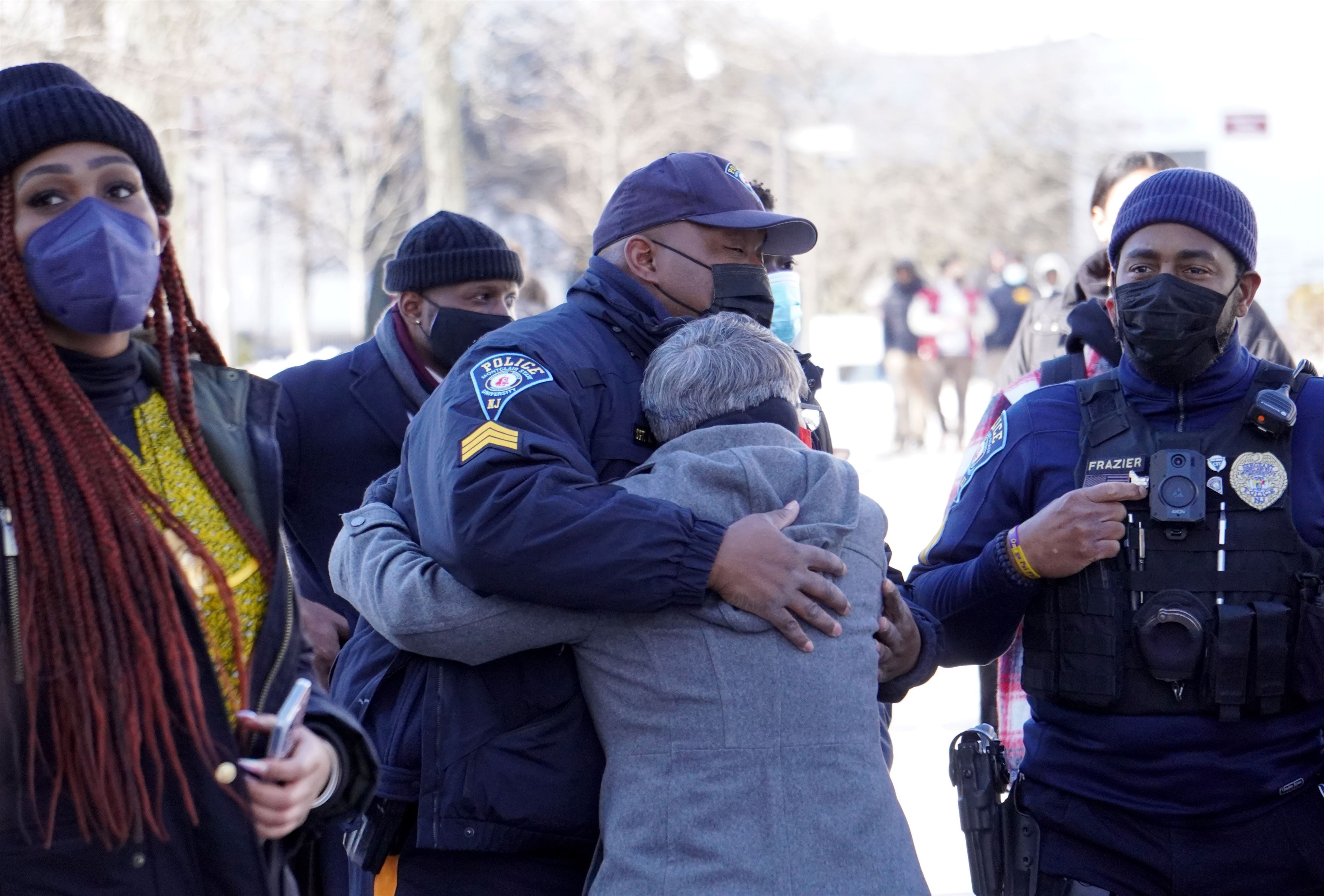 A Montclair State police officer receiving a hug before the Black History Month opening ceremony. Lynise Olivacce | The Montclarion
