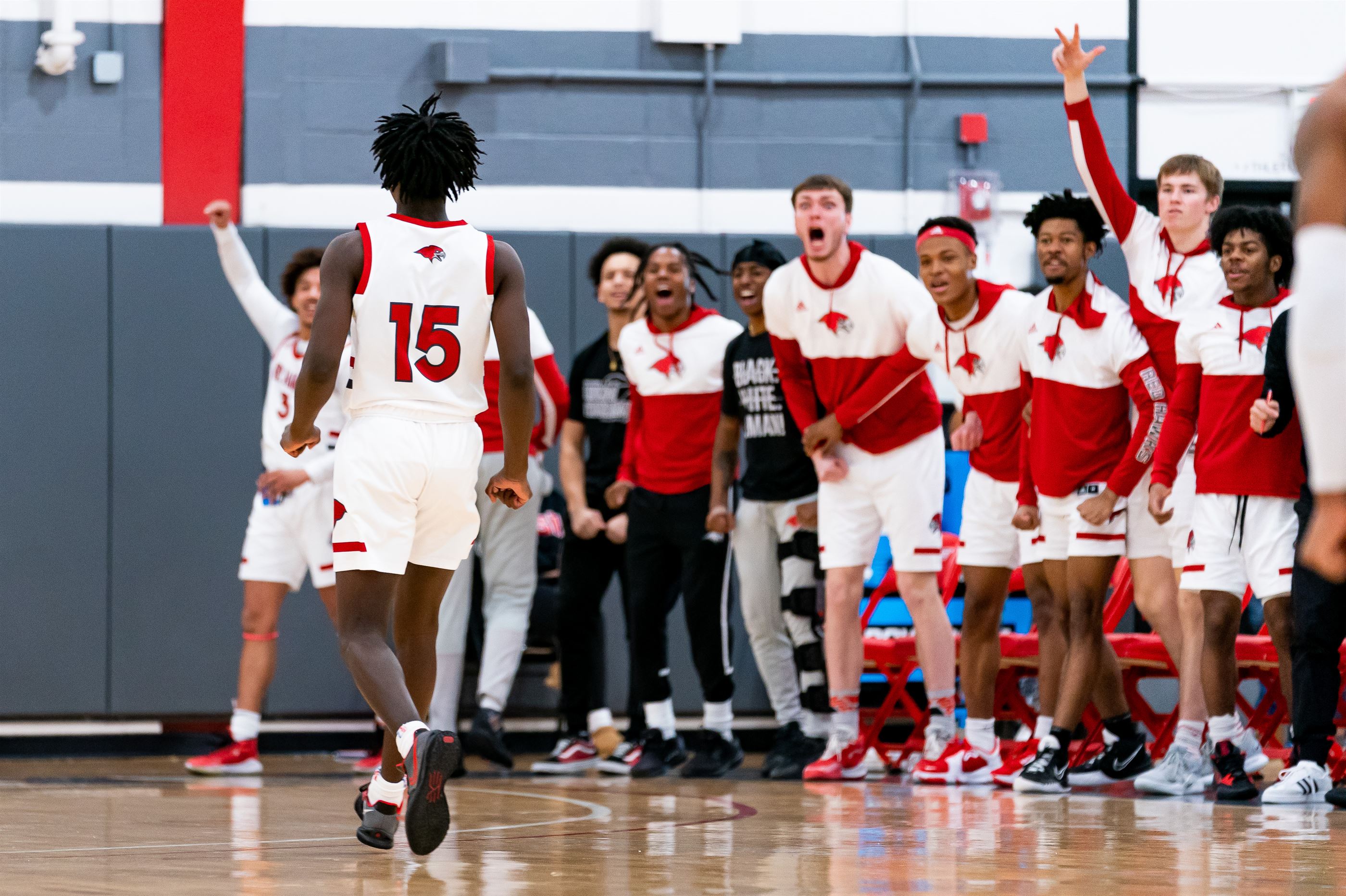 Mike Jackson is hyped up by his teammates after a big basket.