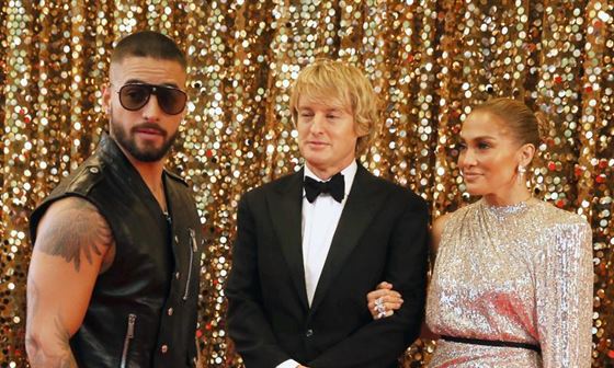 Charlie (played by Owen Wilson) and Kat (played by Jennifer Lopez) make their first appearance on the red carpet together and unexpectedly run into Bastian (Maluma). Photo courtesy of Universal Pictures