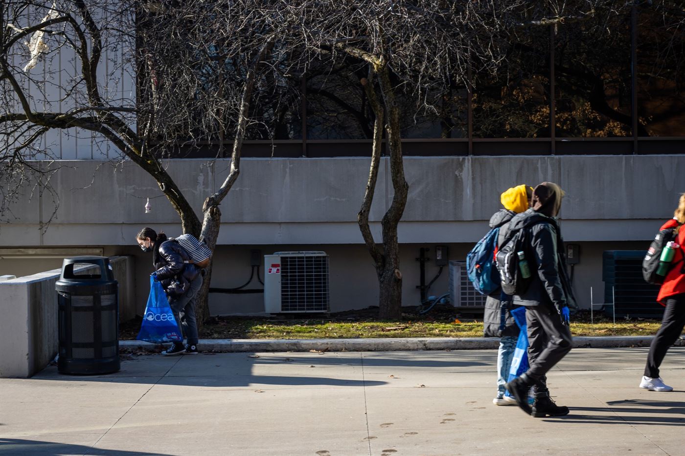 A participant picks up garbage by the student center during the event. Julian Rigg | The Montclarion
