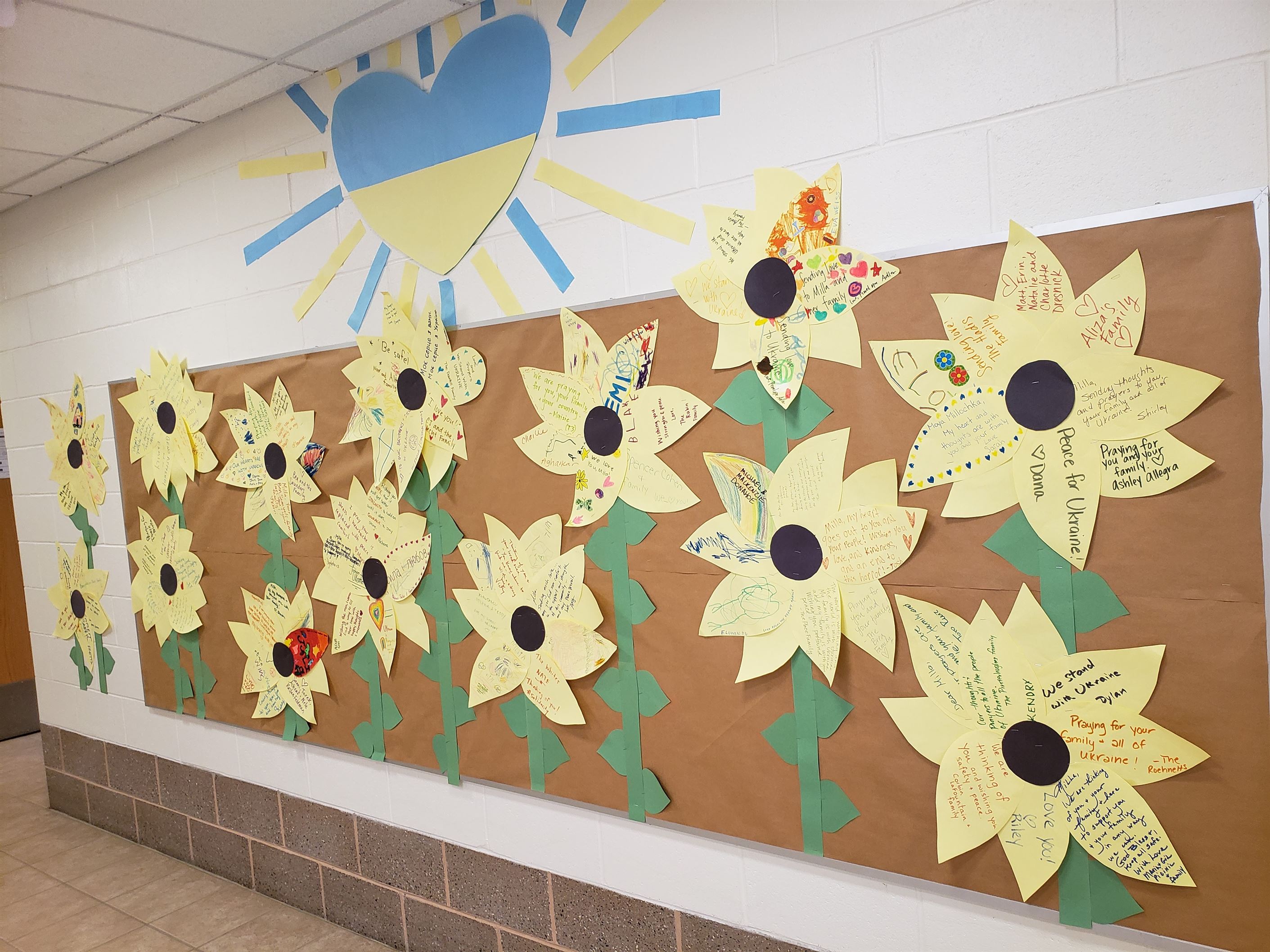 A board of sunflowers in the Ben Samuels Children's Center at Montclair State. The sunflowers are adorned with messages standing in support of Ukraine, and offering prayers to its people.