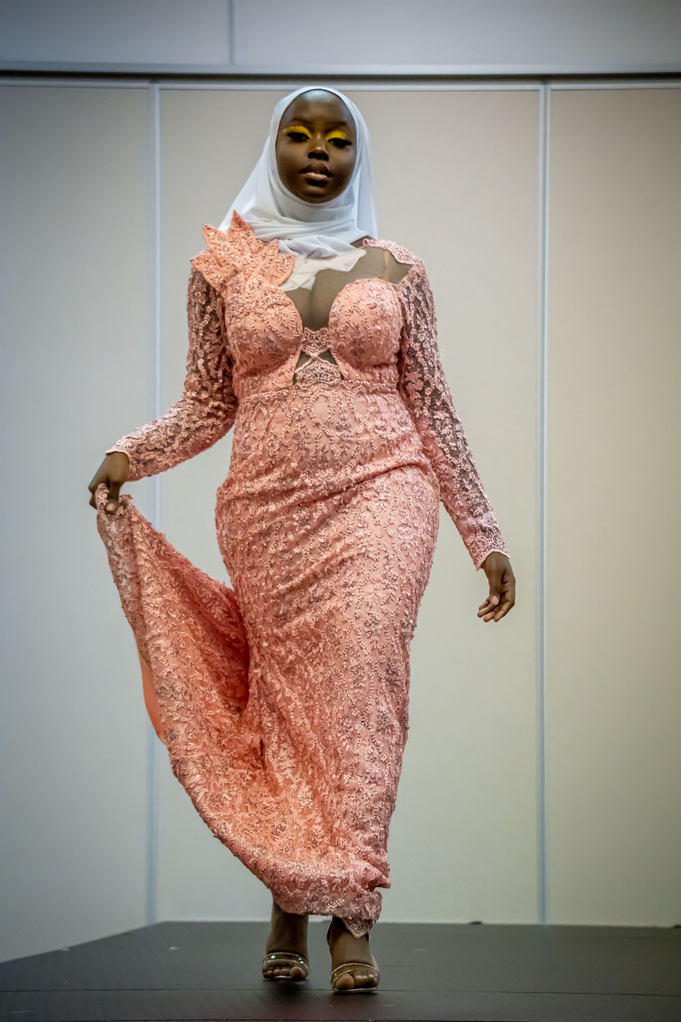 Fatoumata Amar, the new Mrs. NASO and senior fashion studies major, walks down the runway during the Formal category. Lynise Olivacce | The Montclarion