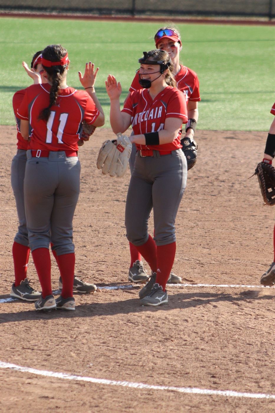 Ali Cavallaro (#14) hands out high-fives to her teammates. Trevor Giesberg | The Montclarion