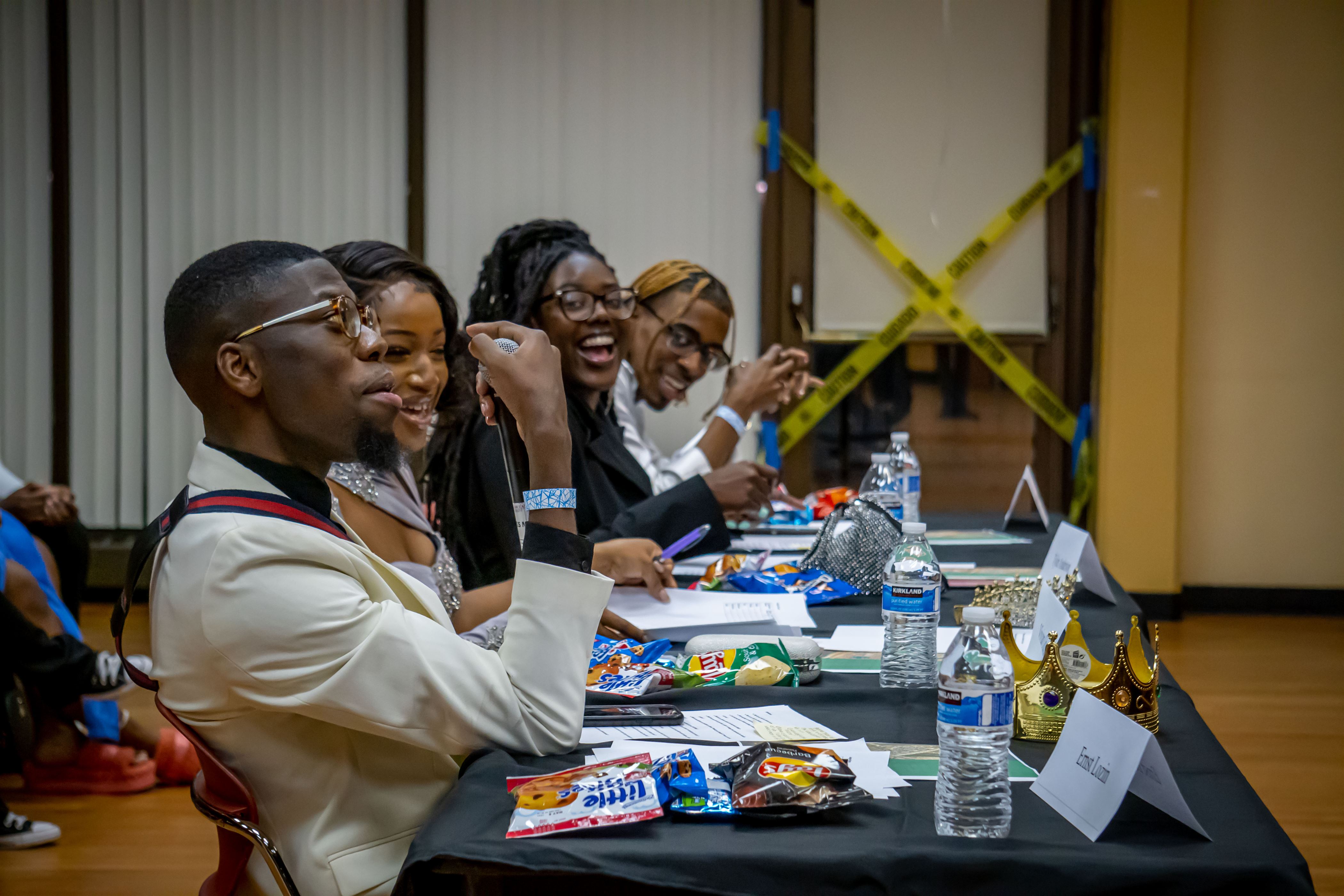 (From left to right): Mr. NASO Ernst Lozin, and former Mrs. NASO Vivian Odubanjo, along with Tyler Anderson, a senior business administration major, and Na’Dree Stewart, a junior anthropology major talk amongst each other with a contestant. Lynise Olivacce | The Montclarion
