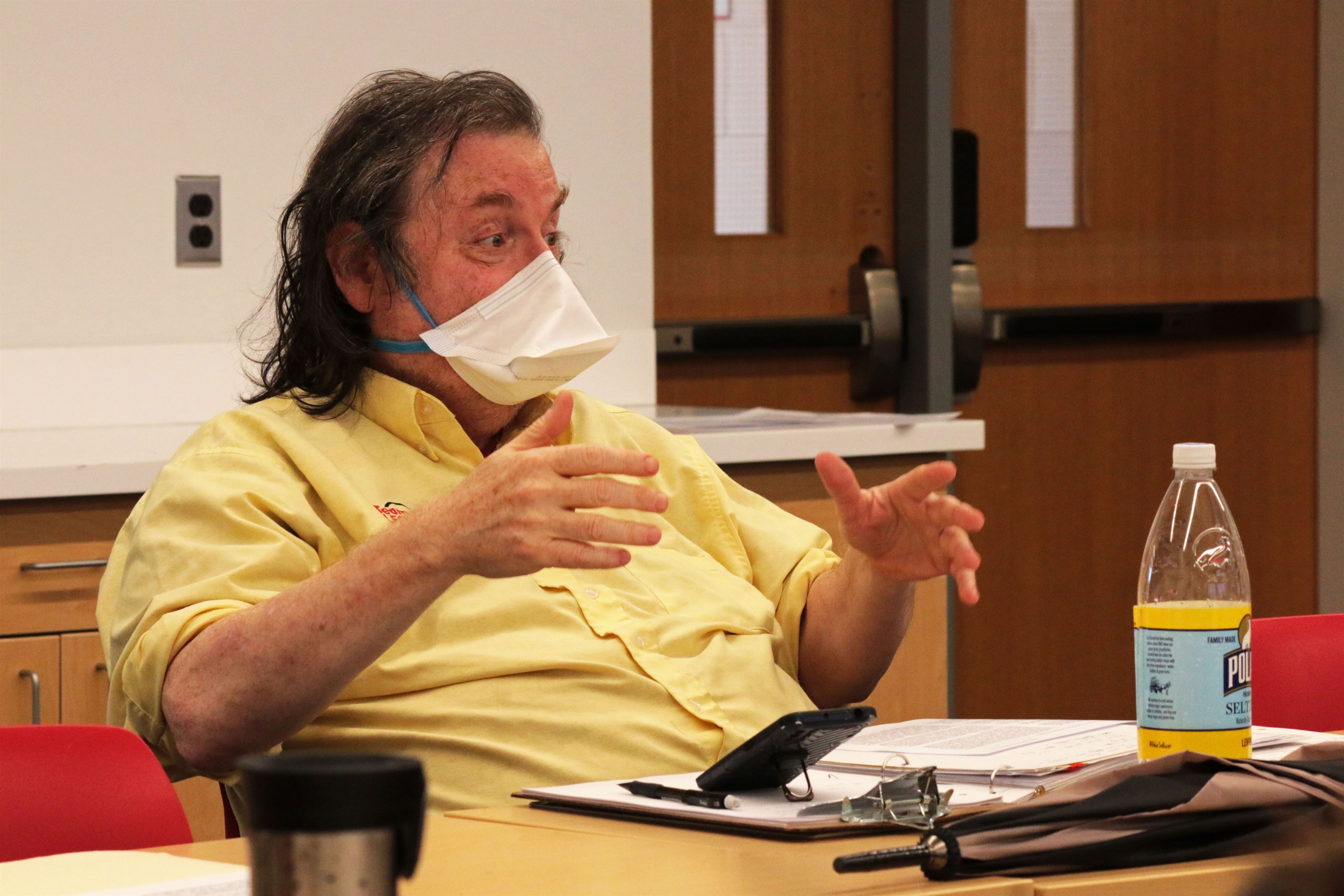 An unidentified person engages with folks in Dickinson Hall for the Philosophy for Lunch program.